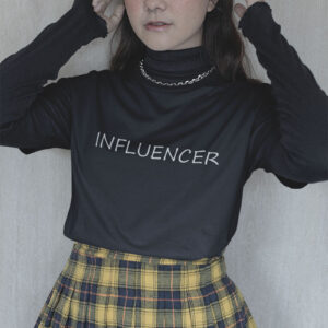 Woman confidently showcasing the 'Influencer' tee by Wake Up Apparel, embodying the essence of digital age trendsetters.