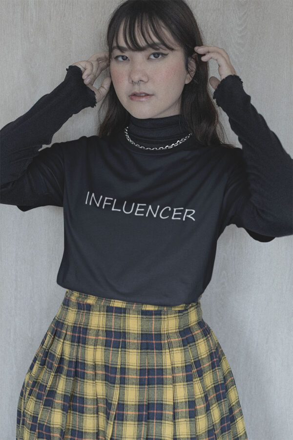 Woman confidently showcasing the 'Influencer' tee by Wake Up Apparel, embodying the essence of digital age trendsetters.