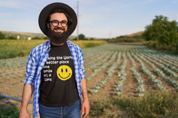 Man in a comfortable-fit T-shirt with the slogan 'Making the world a better place one smile at a time.