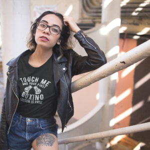 Woman donning a tee with a boxing gloves design and the assertive message 'Touch me and your first boxing lesson is free.'